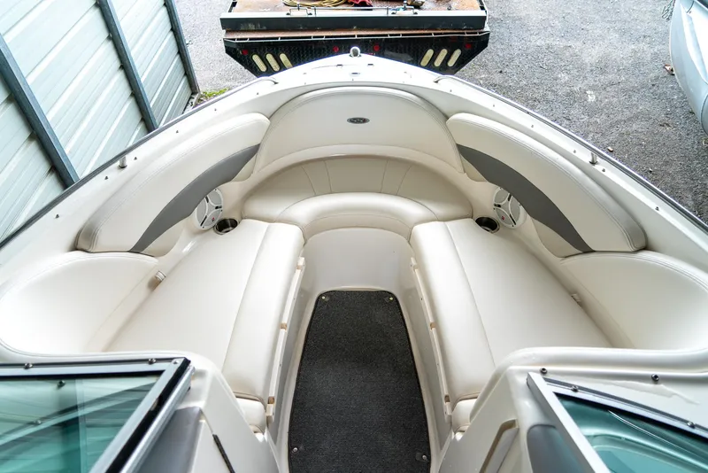 Slide: The Image of 2006 Chaparral 220 SSi boat interior with white seating and carpeted floor. - 14