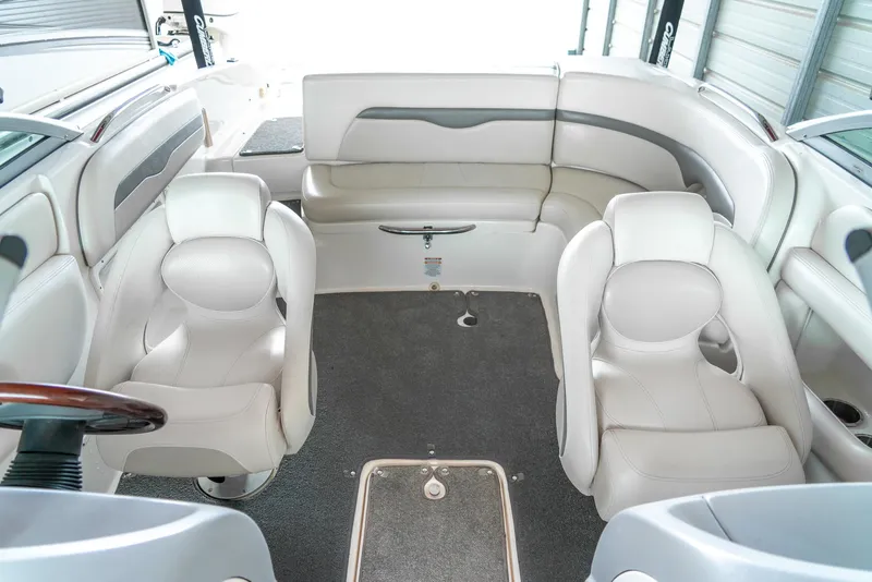 Slide: The Image of 2006 Chaparral 220 SSi boat interior with white seating and carpeted floor. - 16