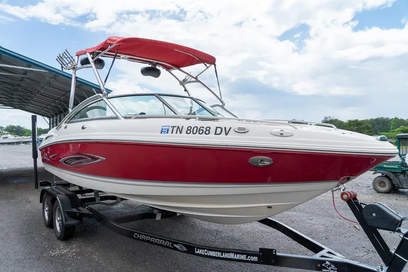 Slide: The Image of 2006 Chaparral 220 SSi boat with red and white exterior on a trailer. - 4