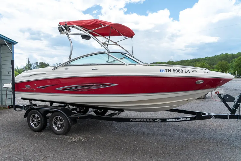 Slide: The Image of 2006 Chaparral 220 SSi boat with red and white design on a trailer. - 5