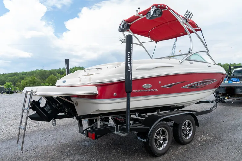Slide: The Image of 2006 Chaparral 220 SSi boat with red and white design on a trailer. - 6