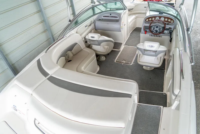 Slide: The Image of 2006 Chaparral 220 SSi boat interior with plush seating and modern dashboard. - 8