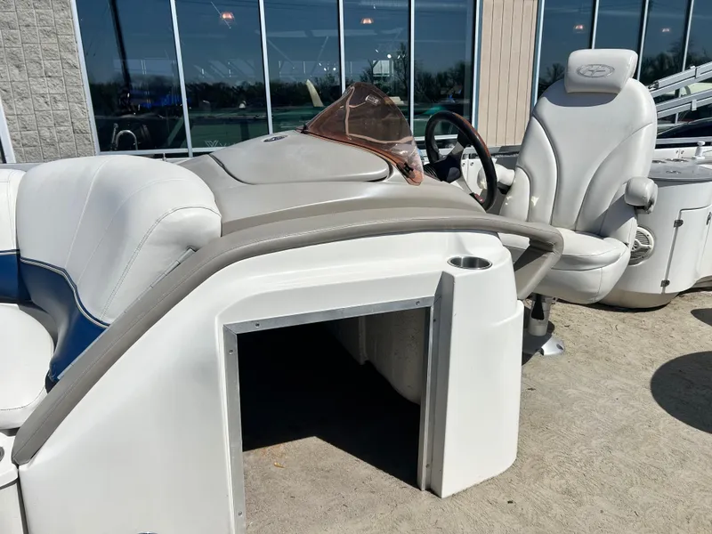 Slide: The Image of 2006 Harris 230 Royal Heritage boat interior with white seating and steering console. - 12