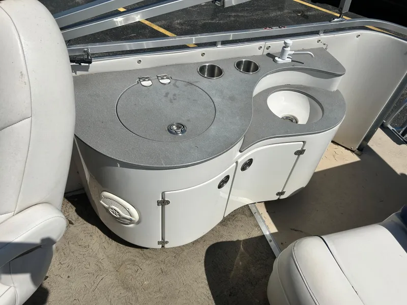 Slide: The Image of 2006 Harris 230 Royal Heritage boat interior with sink and storage area. - 14