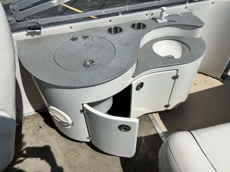 Slide: The Image of 2006 Harris 230 Royal Heritage boat interior with sink and storage cabinet. - 15