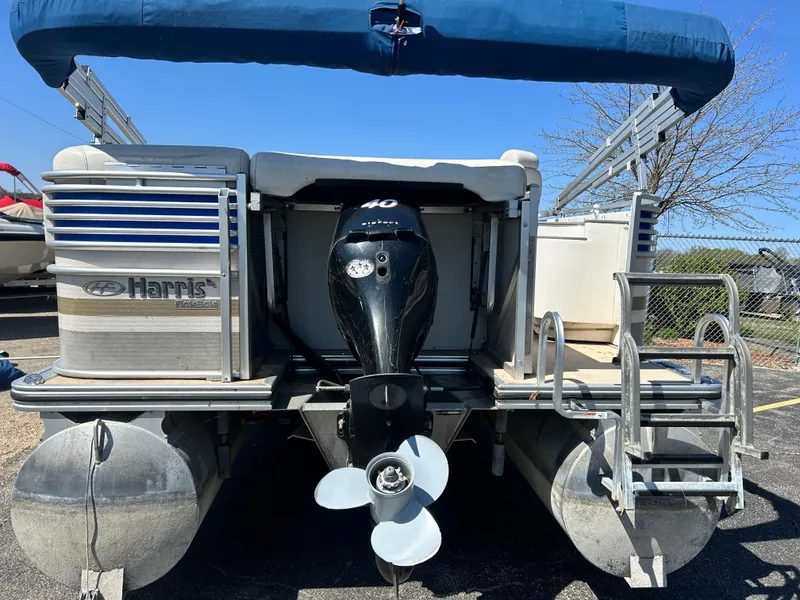 Slide: The Image of 2006 Harris 230 Royal Heritage pontoon boat with outboard motor and blue canopy. - 17