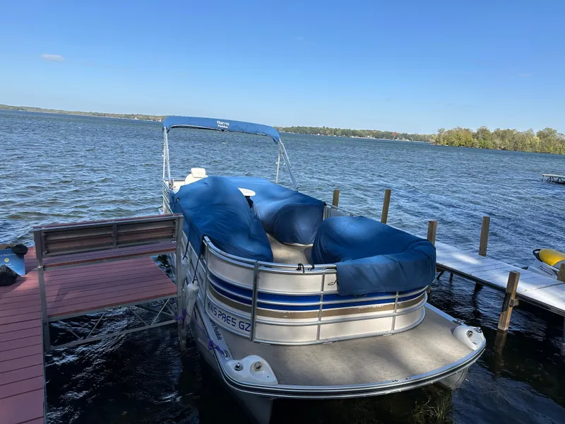 Slide: The Image of 2006 Harris 230 Royal Heritage pontoon boat docked on a sunny lake. - 19
