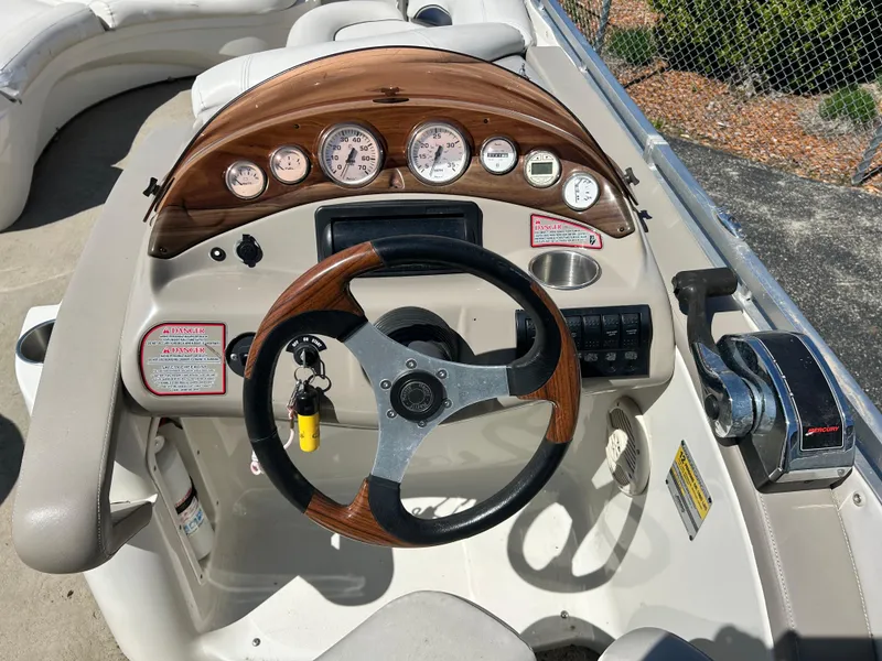 Slide: The Image of Steering console of a 2006 Harris 230 Royal Heritage boat with gauges and controls. - 4