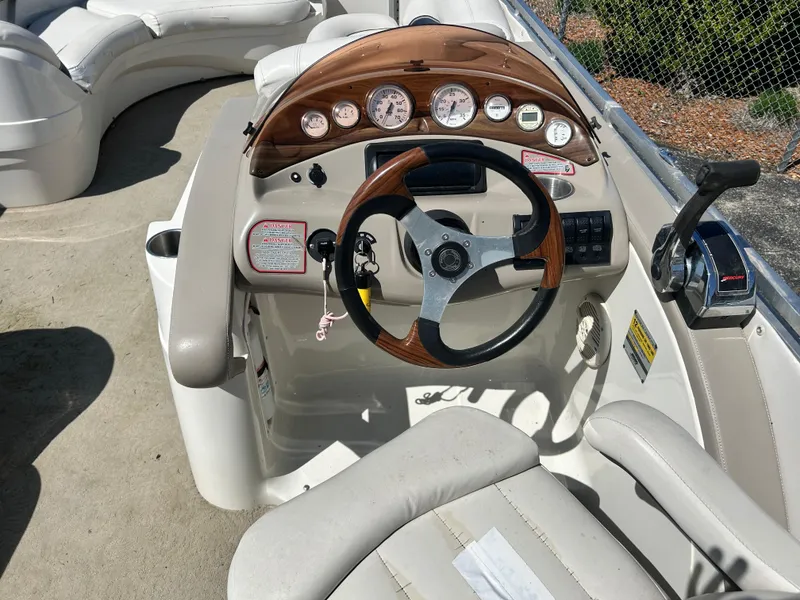 Slide: The Image of Steering console of a 2006 Harris 230 Royal Heritage boat with gauges and controls. - 5