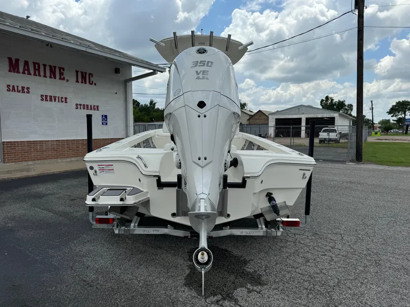 Slide: The Image of 2024 Pathfinder 2600 HPS boat with powerful 350 VE engine, parked outside marine service shop. - 5