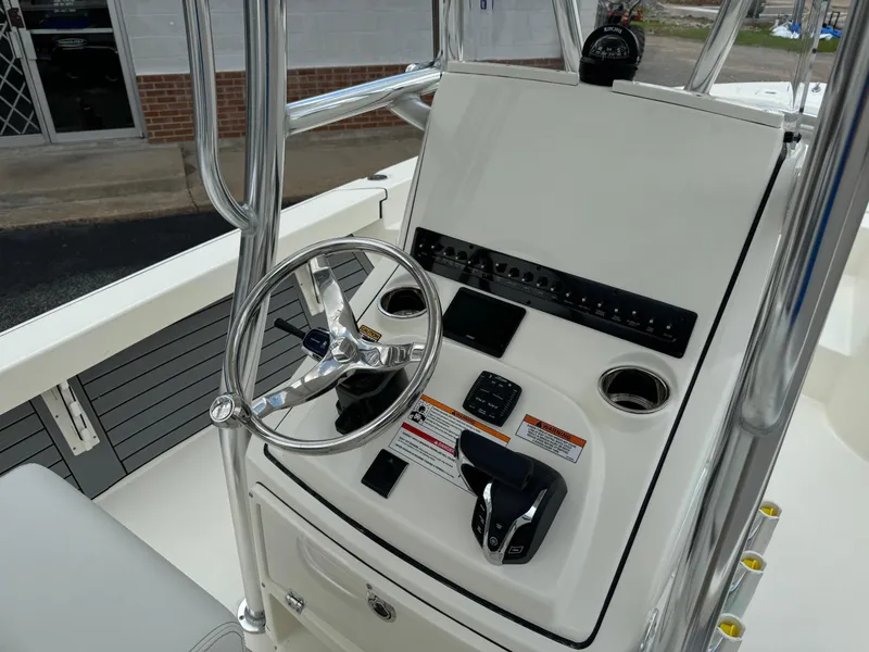 Slide: The Image of 2024 Pathfinder 2600 HPS boat console with steering wheel and controls. - 8