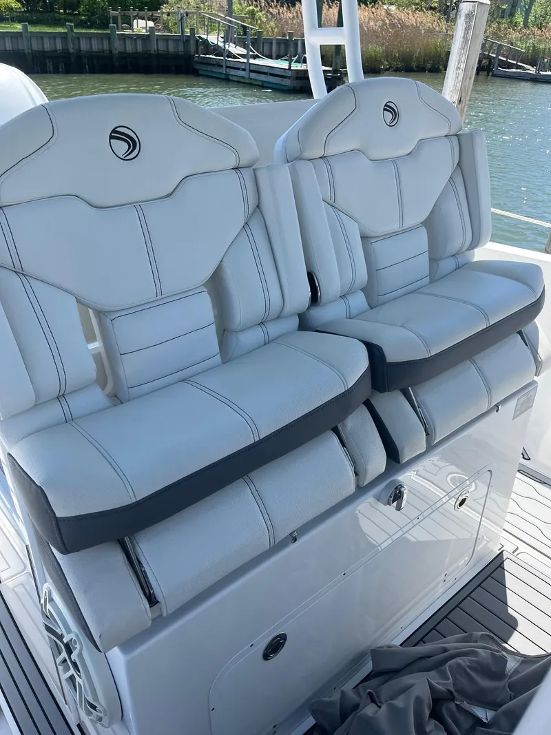 Slide: The Image of 2021 Edgewater 340CC boat seats with white upholstery and sleek design. - 13