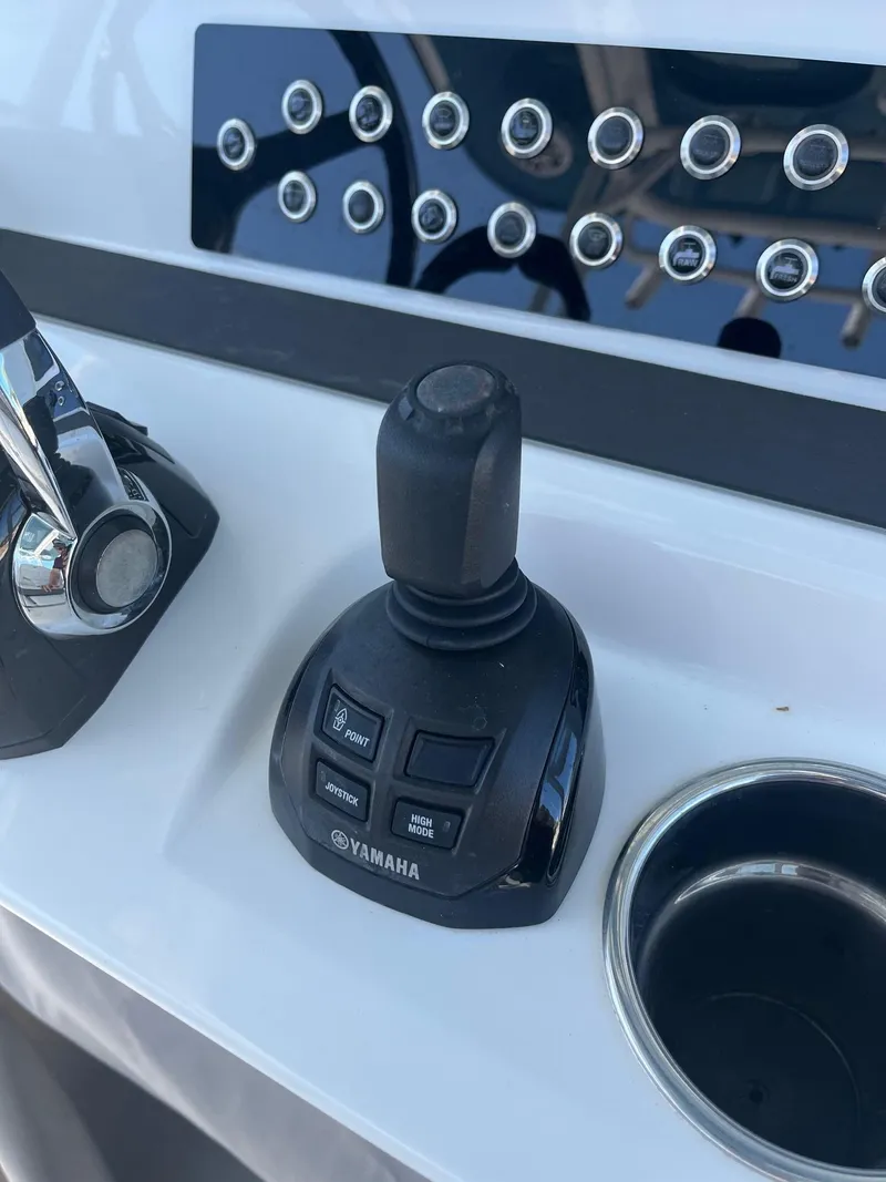 Slide: The Image of Edgewater 340CC 2021 boat control panel with Yamaha joystick and cup holder. - 15