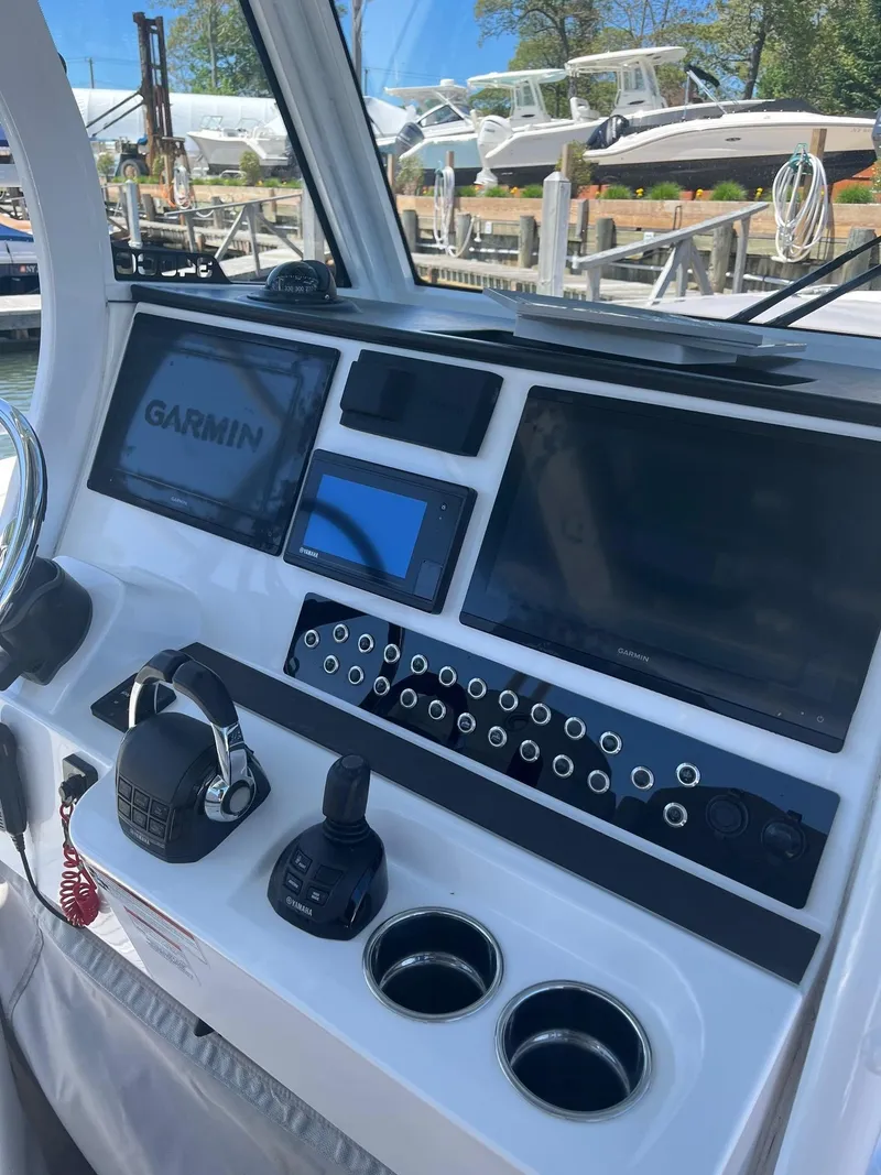 Slide: The Image of Edgewater 340CC 2021 boat dashboard with Garmin navigation system and controls. - 16
