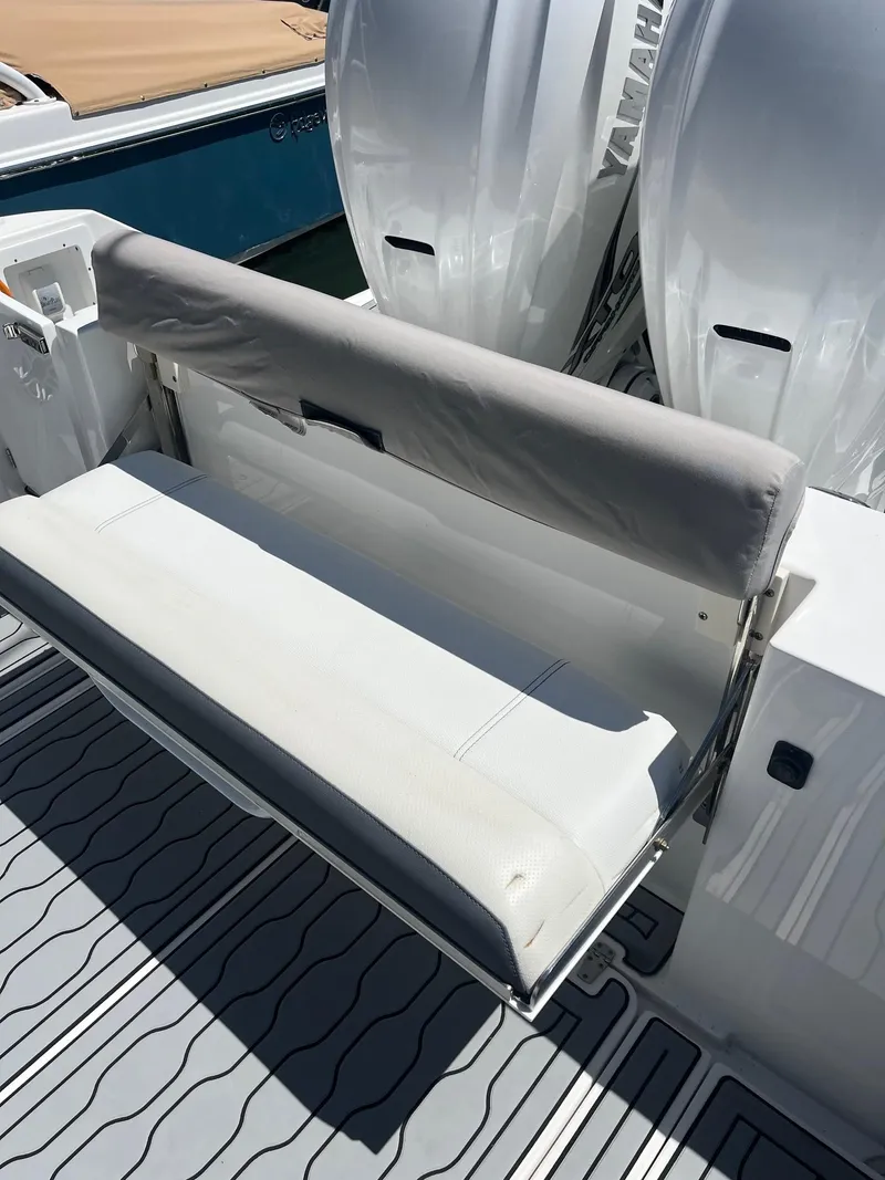 Slide: The Image of 2021 Edgewater 340CC boat with foldable rear bench seat and twin Yamaha outboard engines. - 23