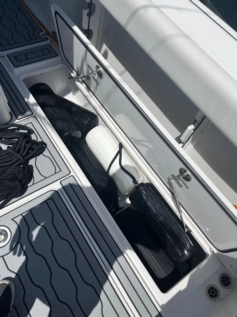 Slide: The Image of Storage compartment on a 2021 Edgewater 340CC boat with fenders and ropes. - 3