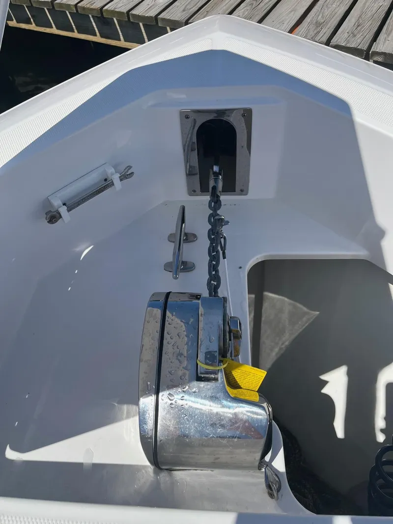Slide: The Image of 2021 Edgewater 340CC boat anchor system with chain and winch on deck. - 8
