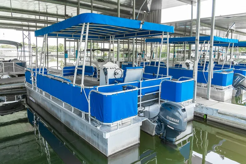Slide: The Image of Custom 2000 pontoon rental fleet with blue canopy and Yamaha outboard motor. - 10