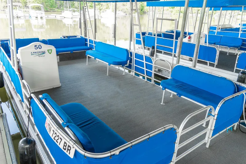 Slide: The Image of Pontoon boat with blue seating, part of a 2000 Custom Pontoon Rental Fleet. - 13