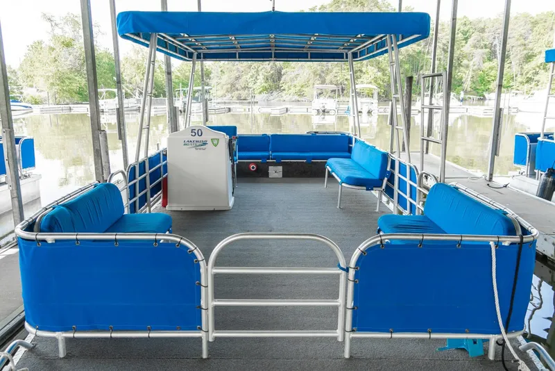 Slide: The Image of Pontoon boat with blue seating and canopy, Custom Pontoon Rental Fleet, 2000 model. - 15
