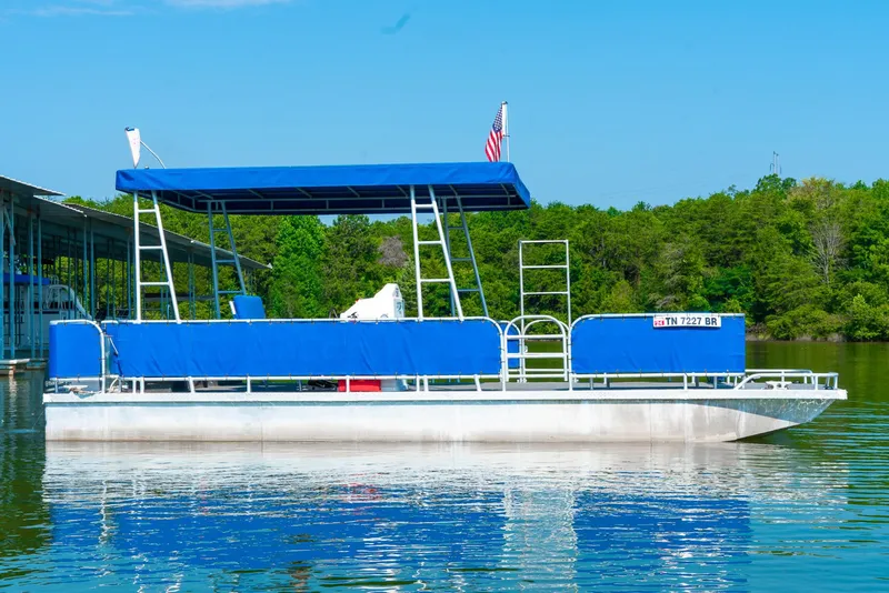 Slide: The Image of Pontoon boat with blue canopy on a calm lake, surrounded by lush greenery. - 8