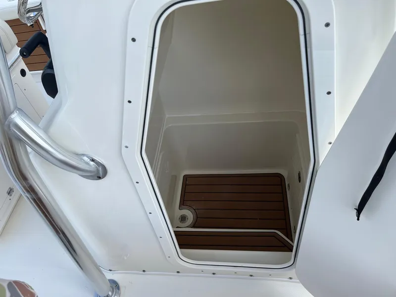 Slide: The Image of Pathfinder 2400 Open 2025 boat interior with wooden flooring and stainless steel railing. - 13