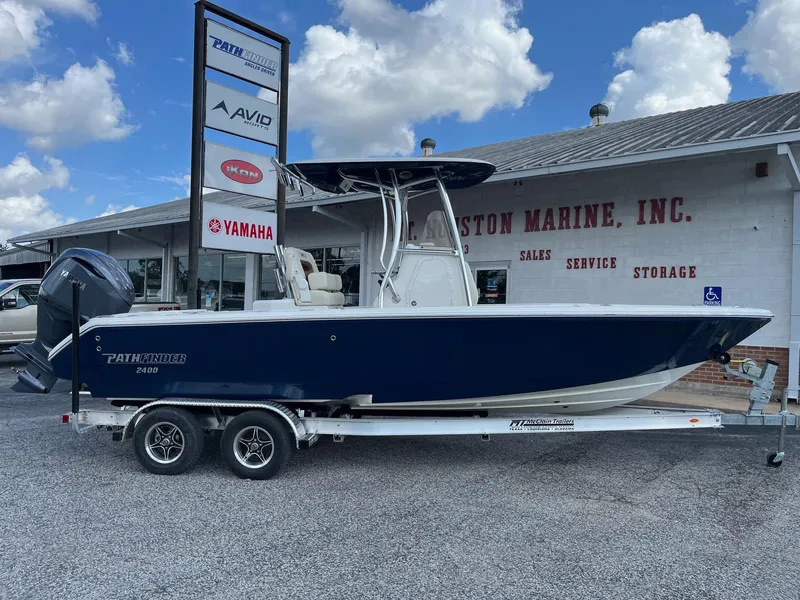 Slide: The Image of 2025 Pathfinder 2400 Open boat on trailer at dealership, blue hull, Yamaha engine. - 3