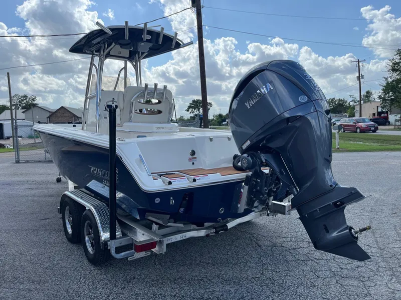 Slide: The Image of 2025 Pathfinder 2400 Open boat on trailer with Yamaha outboard motor, parked outdoors. - 4
