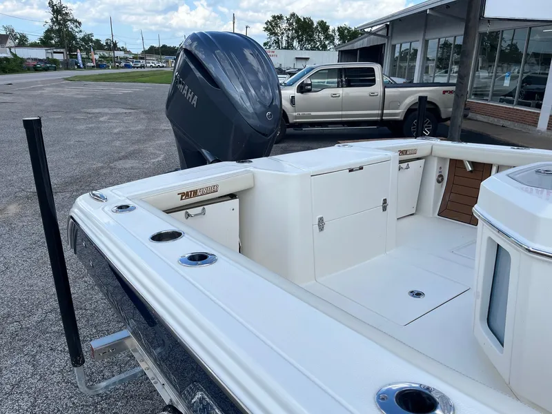 Slide: The Image of 2025 Pathfinder 2400 Open boat with Yamaha engine, parked near a dealership. - 6