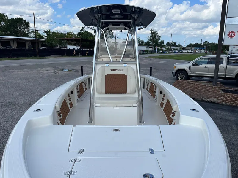 Slide: The Image of 2025 Pathfinder 2400 Open boat with T-top, parked outdoors under a cloudy sky. - 8