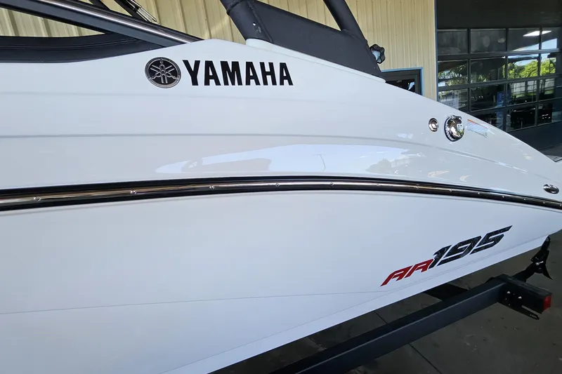 Slide: The Image of 2025 Yamaha AR195 boat side view, showcasing sleek white design and branding. - 3