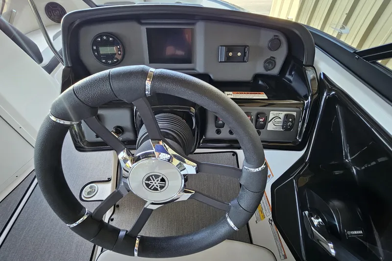 Slide: The Image of 2025 Yamaha Boats AR195 steering wheel and dashboard controls. - 7