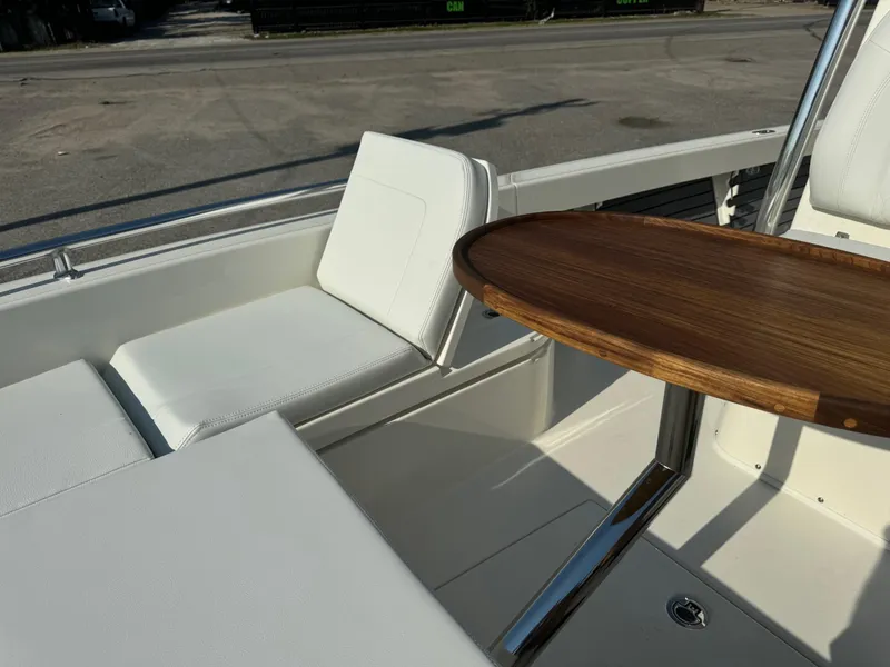 Slide: The Image of 2025 Pathfinder 2600 TRS boat interior with white seating and wooden table. - 10