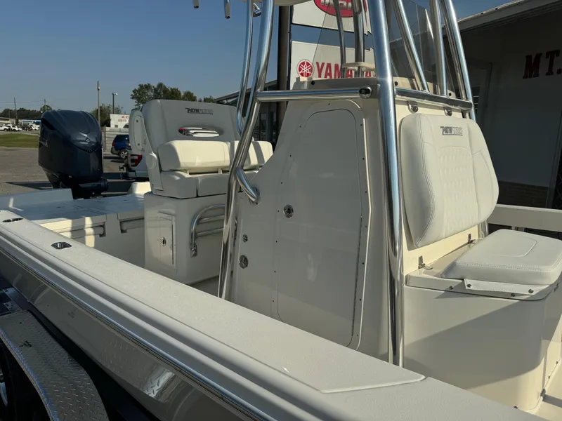 Slide: The Image of 2025 Pathfinder 2600 TRS boat with seating and console, parked outdoors. - 13