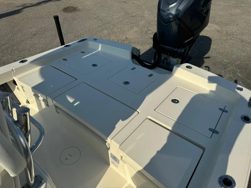 Slide: The Image of 2025 Pathfinder 2600 TRS boat deck with storage compartments and outboard motor. - 7