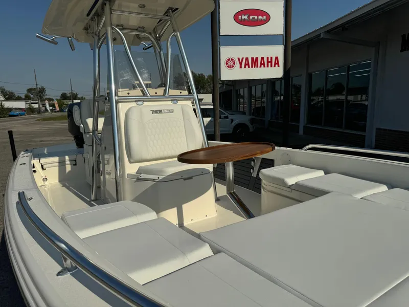 Slide: The Image of 2025 Pathfinder 2600 TRS boat with seating and table, displayed at a Yamaha dealership. - 8