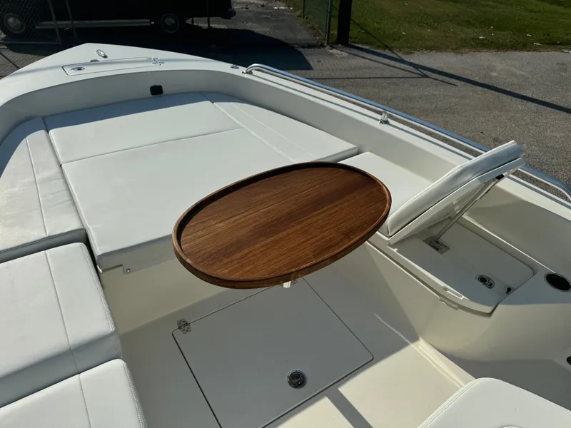 Slide: The Image of 2025 Pathfinder 2600 TRS boat interior with wooden table and white seating. - 9