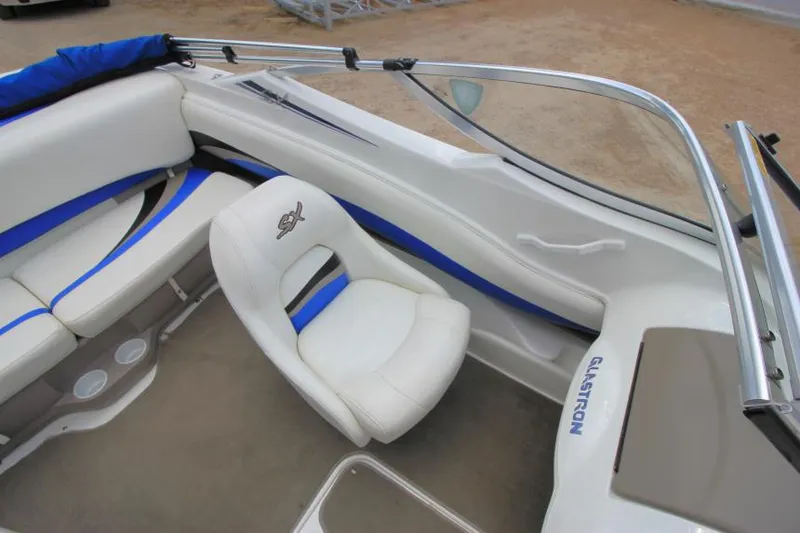 Slide: The Image of 2003 Glastron SX 175 boat interior with white and blue seating. - 11