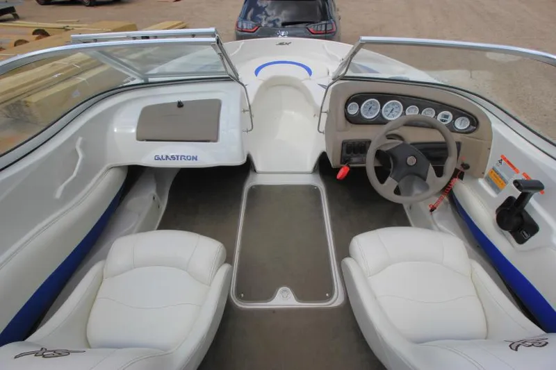 Slide: The Image of 2003 Glastron SX 175 boat interior with steering wheel and seating. - 13