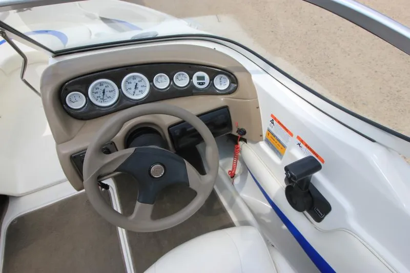 Slide: The Image of 2003 Glastron SX 175 boat dashboard with steering wheel and instrument panel. - 14