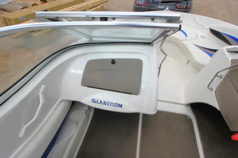 Slide: The Image of 2003 Glastron SX 175 boat interior with open windshield and storage compartment. - 16