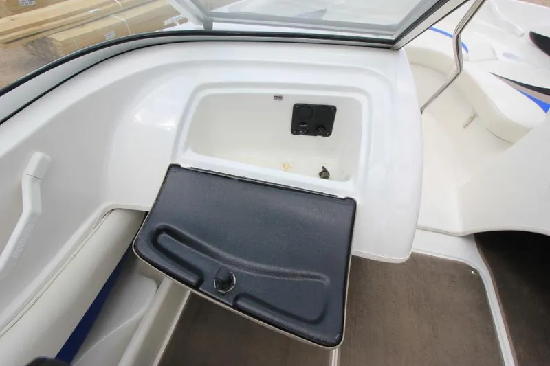 Slide: The Image of 2003 Glastron SX 175 boat interior with open storage compartment and sleek design. - 17