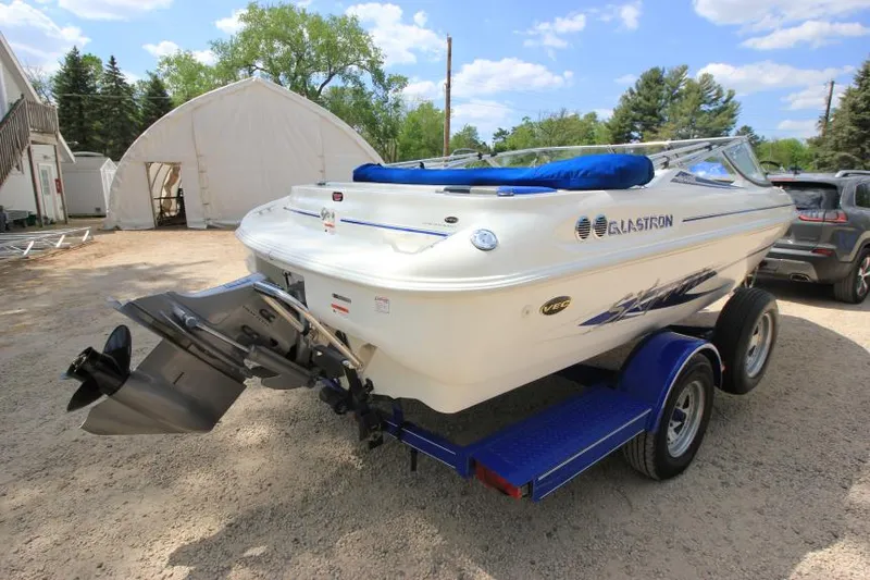 Slide: The Image of 2003 Glastron SX 175 boat on trailer, parked outdoors. - 2