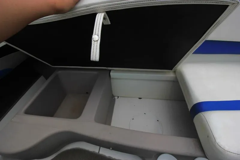 Slide: The Image of 2003 Glastron SX 175 boat storage compartment with open lid and seating area. - 21