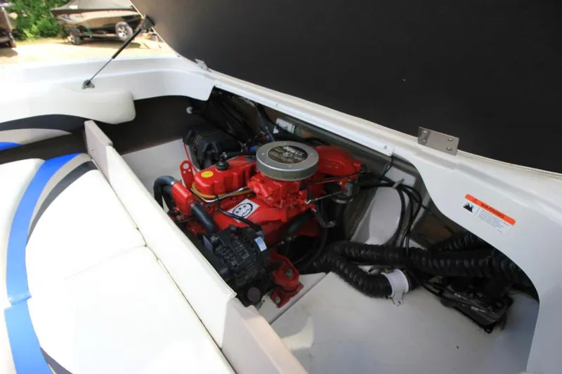 Slide: The Image of 2003 Glastron SX 175 boat engine compartment with red engine components. - 22