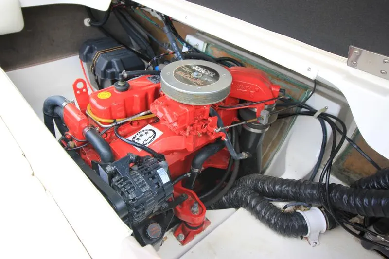 Slide: The Image of 2003 Glastron SX 175 engine compartment with red engine components and wiring. - 23