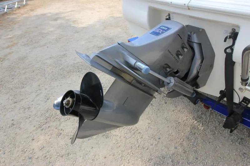 Slide: The Image of 2003 Glastron SX 175 boat outboard motor and propeller on gravel surface. - 3