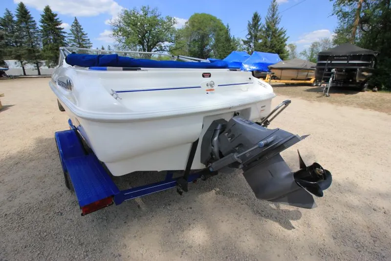 Slide: The Image of 2003 Glastron SX 175 boat on trailer, parked outdoors, rear view. - 5