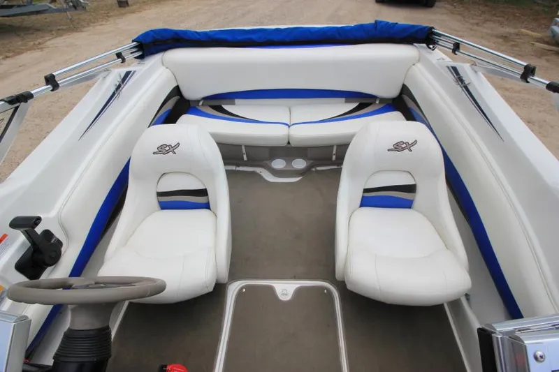 Slide: The Image of 2003 Glastron SX 175 boat interior with white and blue seating. - 9