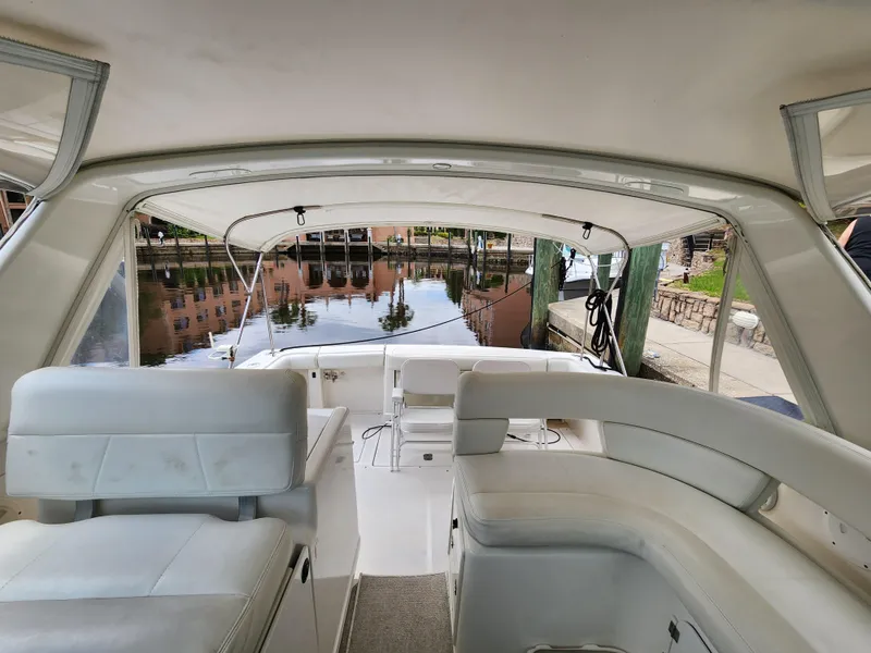 Slide: The Image of 2001 Tiara Yachts 3100 Open interior with white seating, dockside view. - 10